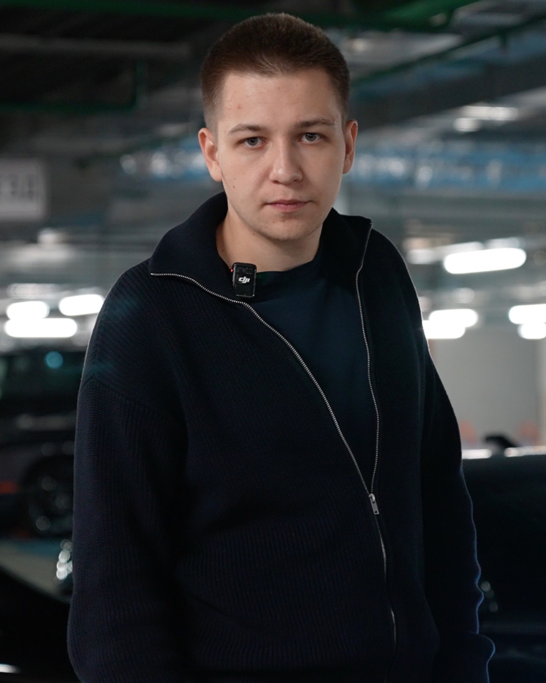 Artem — founder, in a parking garage with a DJI clip-on mic on his collar